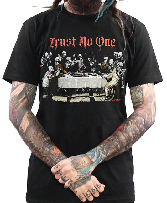 A person wearing a black T-shirt with a graphic print of 'Trust No One' depicting a group of people around a table.