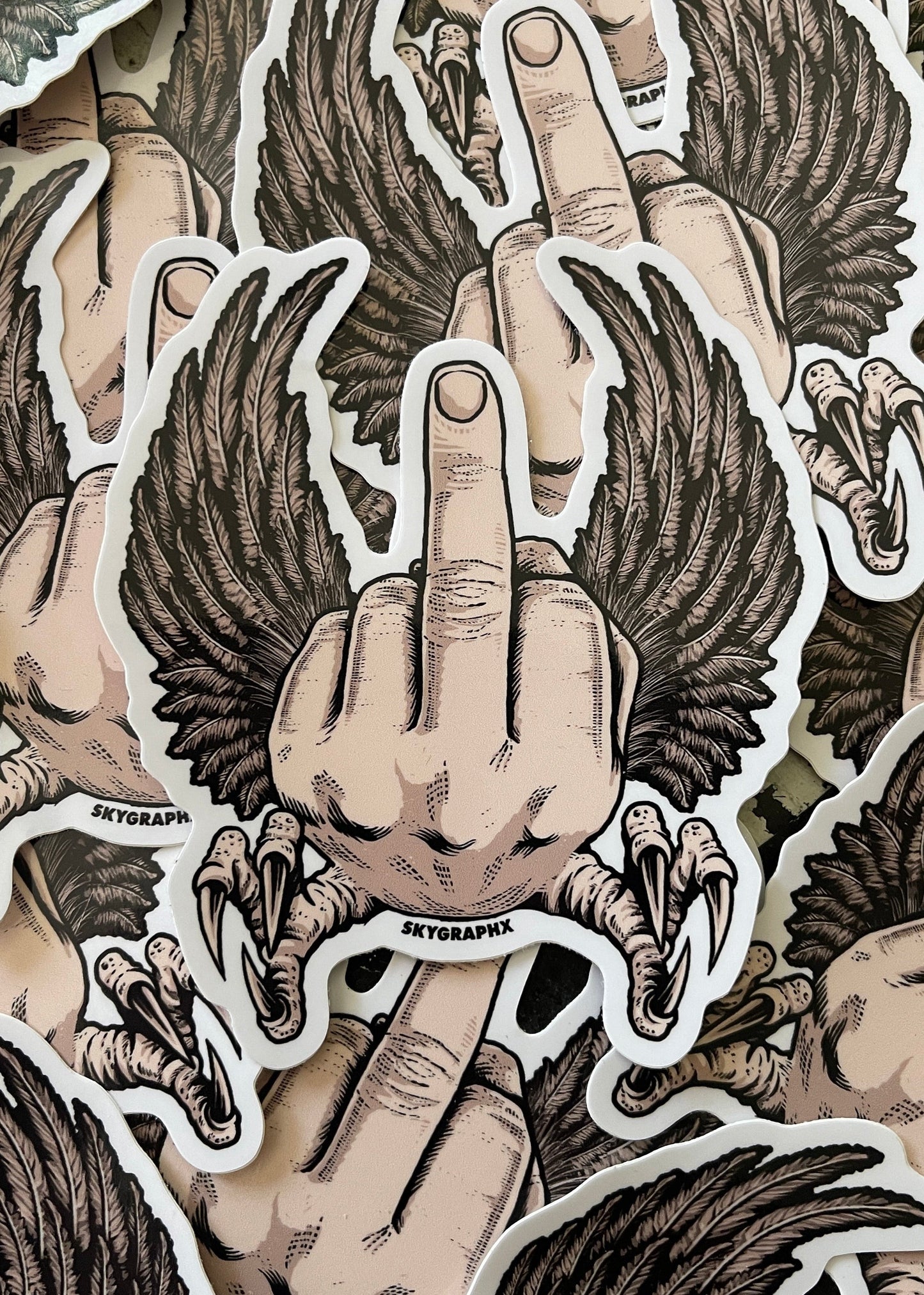 Sticker design of a hand with wings giving the middle finger, featuring the brand 'Skygraphx'.