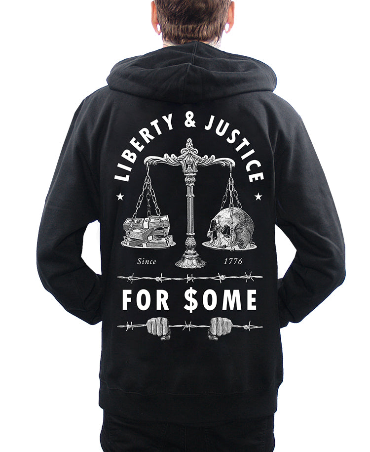model wearing hoodie with liberty and justice for some money and skull and justice scales