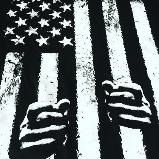 close up of black and white american flag with hands holding stripes like jail