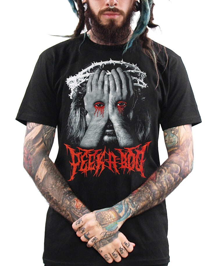 model wearing a shirt with jesus looking through stigmata hands and says peek a boo