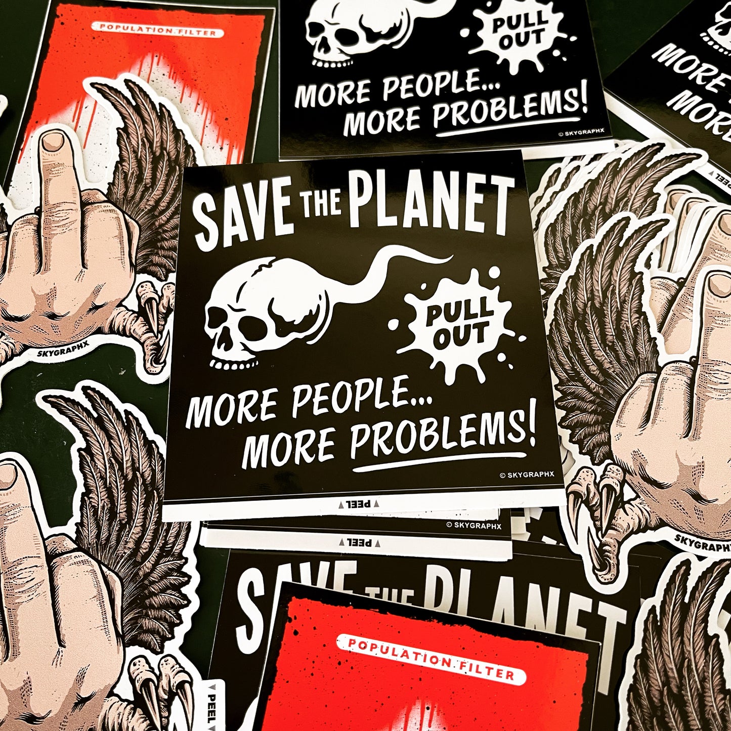 collection of save the planet, flying fucks and population filter stickers on a table