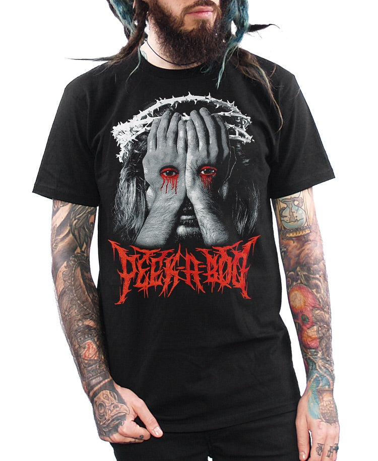model wearing a shirt with jesus looking through stigmata hands and says peek a boo