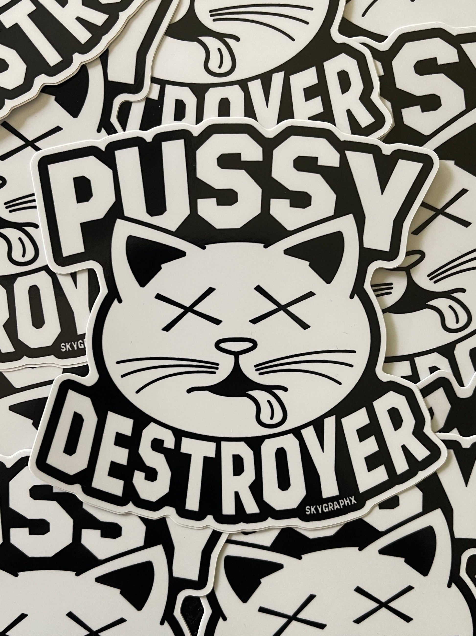 Sticker design with cat face and text 'PUSSY DESTROYER' on a patterned background