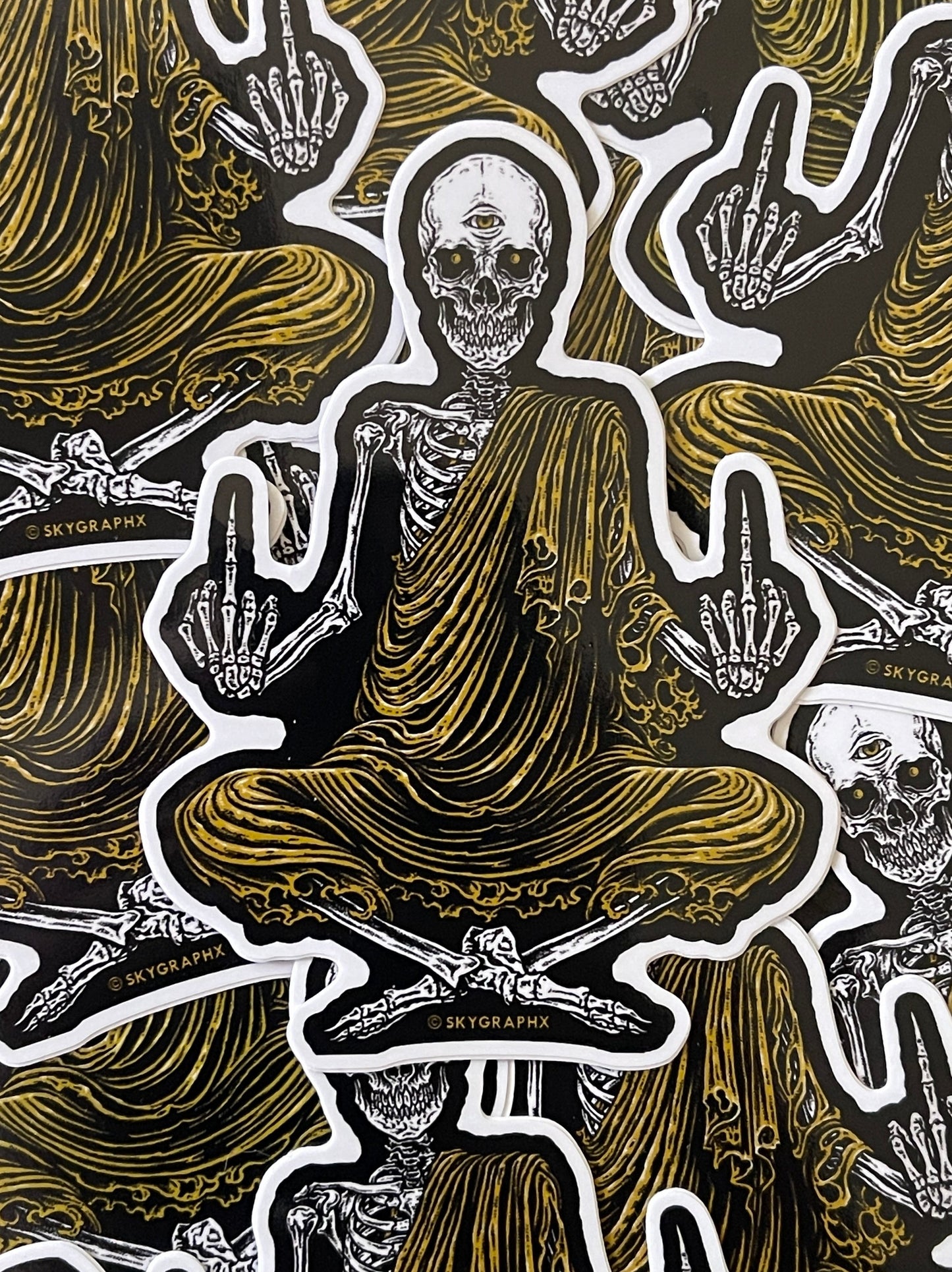Pattern of a skeleton in a meditative pose with hands in a peace sign, on a dark background.